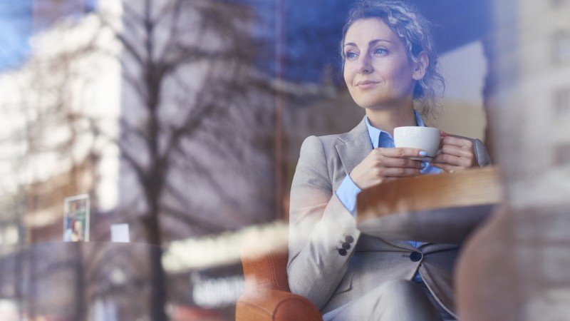 Woman in formalwear resting in café